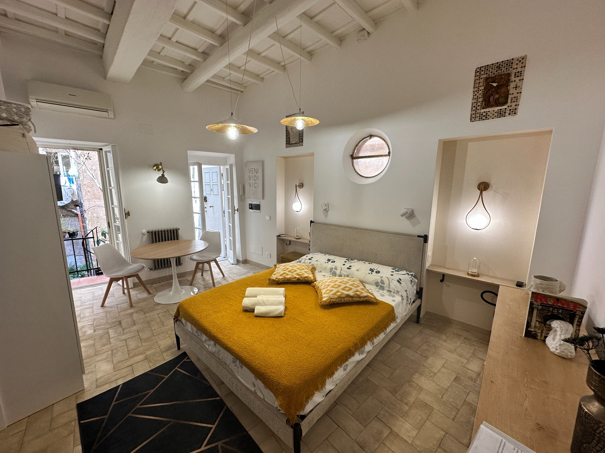 Main room with double bed and dining area